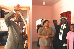Chief Kasekete’s brother Mr Wilson Mutinhima shows Acting President Joice Mujuru the house Prophet Emmanuel Makandiwa built for the chief in Muzarabani yesterday. Looking on is the chief and other guests