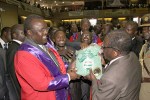 President Mugabe hands over a packet of maize seed to Chief Fortune Charumbira while Chief Musarurwa and other chiefs look on at the launch of the US$27 million Presidential Well Wishers Special Inputs Scheme in Harare