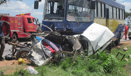 A passerby views the wreckage of a Toyota Hilux which collided head-on with a Zupco bus along the Kwekwe-Gweru Road yesterday morning, killing four people on the spot.