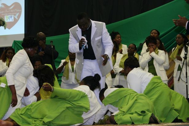 Female worshippers literally fall at shamed preacher Masocha's feet at an Agape service