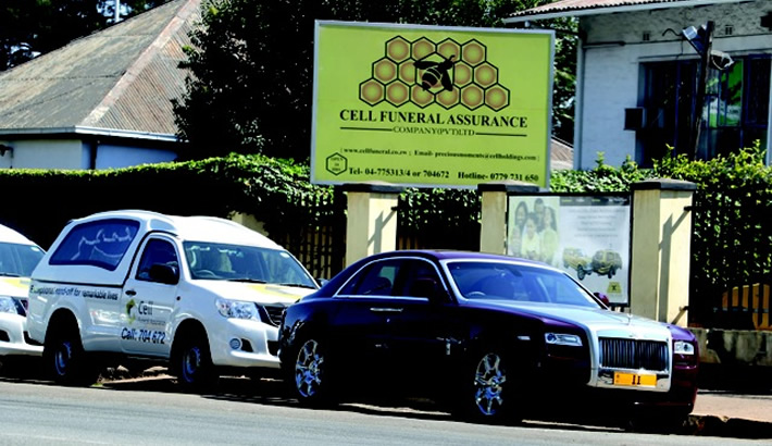APPARITIONAL... The controversial Rolls Royce Ghost owned by businessman Frank Buyanga and parked at his Cell Funeral Assurance offices along new hearses in Harare's Herbert Chitepo Street. (Picture by Daily News)