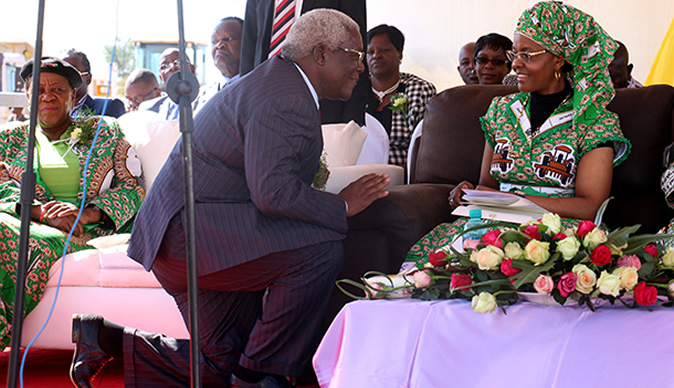 Minister Chombo kneeling before Grace Mugabe at a rally