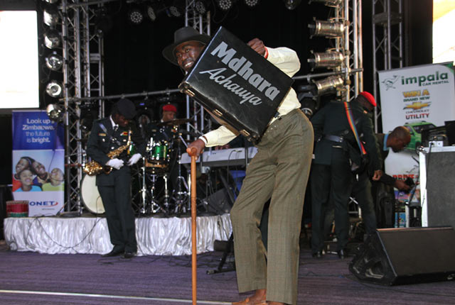 FANFARE . . . A fan joins Jah Prayzah’s band on stage holding a ‘Mdhara Achauya’ briefcase