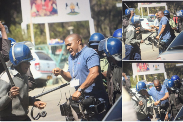 Riot police assaulting a journalist and smashing his camera during the demonstrations on Wednesday (Picture by Journalist Nomsa Maseko via Twitter)