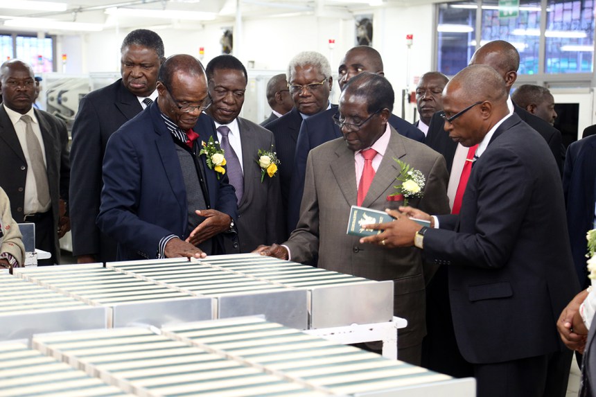 President Mugabe is taken through passport production stages by the Registrar-General Tobaiwa Mudede and his the Head of Information Technology Mr Henry Machiri (right) while Vice Presidents Phelekezela Mphoko and Emmerson Mnangagwa and Home Affairs Minister Dr Ignatius Chombo look on after the official opening of the National Passport Production Centre in Harare