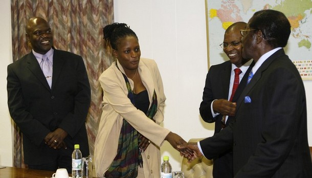Zimbabwean President Robert Mugabe (R) greets MDC 's secretary general deputy Priscilla Misihairibwi-Mushonga as Arthur Mutambara (R) head of the dissident MDC faction and MDC secretary general Welshman Ncube (R/background) look on, before convening for a round table meeting with South African President, chief negotiator Thabo Mbeki (out of camera range) in Harare, on July 05, 2008. Mbeki had a brief discussion with Mugabe, whose re-election last month has been rejected by the opposition leader Morgan Tsvangirai and his Movement for Democratic Change (MDC).