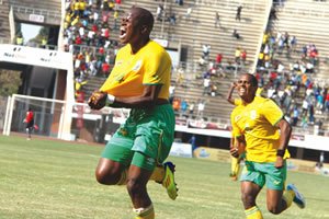 willard katsande UNBRIDLED JOY . . . Willard Katsande (left) celebrates after scoring the Warriors opening goal aganist Liberia at the National Sports Stadium yesterday, while Quincy Antipas rushes in to congratulate him