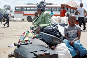 Mrs Agnes Nyamuzuwe waits for transport to be ferried to her rural home for Christmas from Mbare Musika on Friday