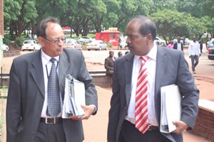 Mujuru family lawyer Mr Thakor Kewada (left) who was being helped by SA pathologist, Dr Reggie Perumel