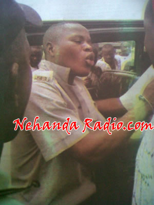 A policeman being arrested for allegedly receiving a bribe