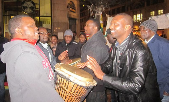 Members of the Zimbabwe Vigil protesting outside the Zimbabwean Embassy in London