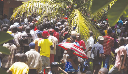 Scene at Hatcliffe Number 1 Primary School in Harare where two Grade 5 pupils reportedly turned into baboons after being given bracelets and rings by their class teacher, attracting thousands of people. Here, policemen bar the crowd from entering the school yard and the offices, and people battling to catch a glimpse of the affected pupils