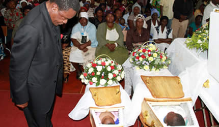 Webster Shamu pays his last respects to the two children and their mother who died after being struck by a car on their way home after attending the main Independence Day Anniversary celebrations, at Assemblies of God Church in Warren Park 1, Harare, yesterday. Rumbidzai (6) and Nyasha (18 months) were killed together with their mother, Simbisai Mumango. — Picture by Kudakwashe Hunda