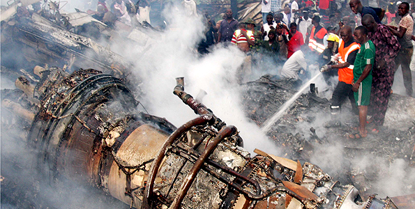 Firefighters try to put out the fire at the site of a plane crash near the Lagos airport in Nigeria, June 3, 2012. A passenger plane carrying 153 people crashed into a two-storey building in Nigeria's southwestern Lagos State