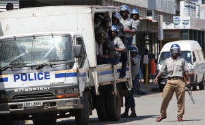 Zimbabwean riot police move in to quash a meeting organized by the Movement For Democratic Change, MDC, at their party headquarters in Harare Sunday April 3, 2011
