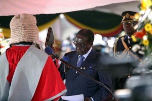 Chief Justice Godfrey Chidyausiku ( red gown) swears in Robert Mugabe as the President of Zimbabwe at the National Sports Stadium.