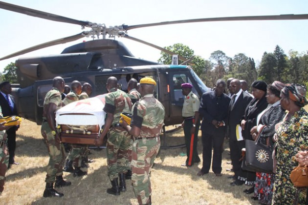 Pallbearers carry the coffin of the late national hero Cde Enos Nkala from a helicopter at Headquarters One Brigade in Bulawayo yesterday.