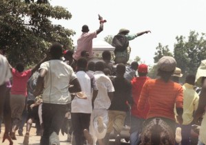 Mourners rally behind the hearse carrying Boris Mushonga's coffin