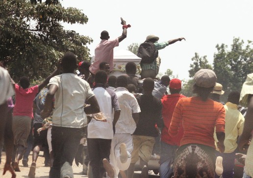 Mourners rally behind the hearse carrying Boris Mushonga's coffin