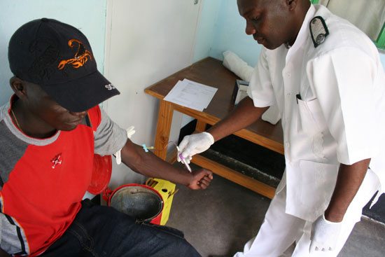 A nurse in Zimbabwe attends to a patient (file photo)