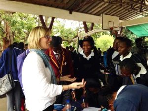 A visiting admissions officer talks to students