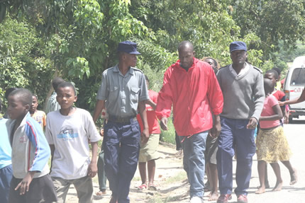 Gilbert Chinamhora is led away by police officers