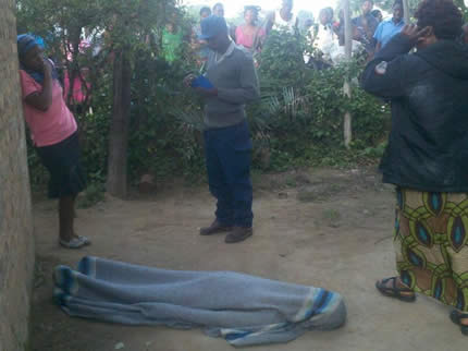 A police officer records statements at the scene of the murder of Talent Chinyowa