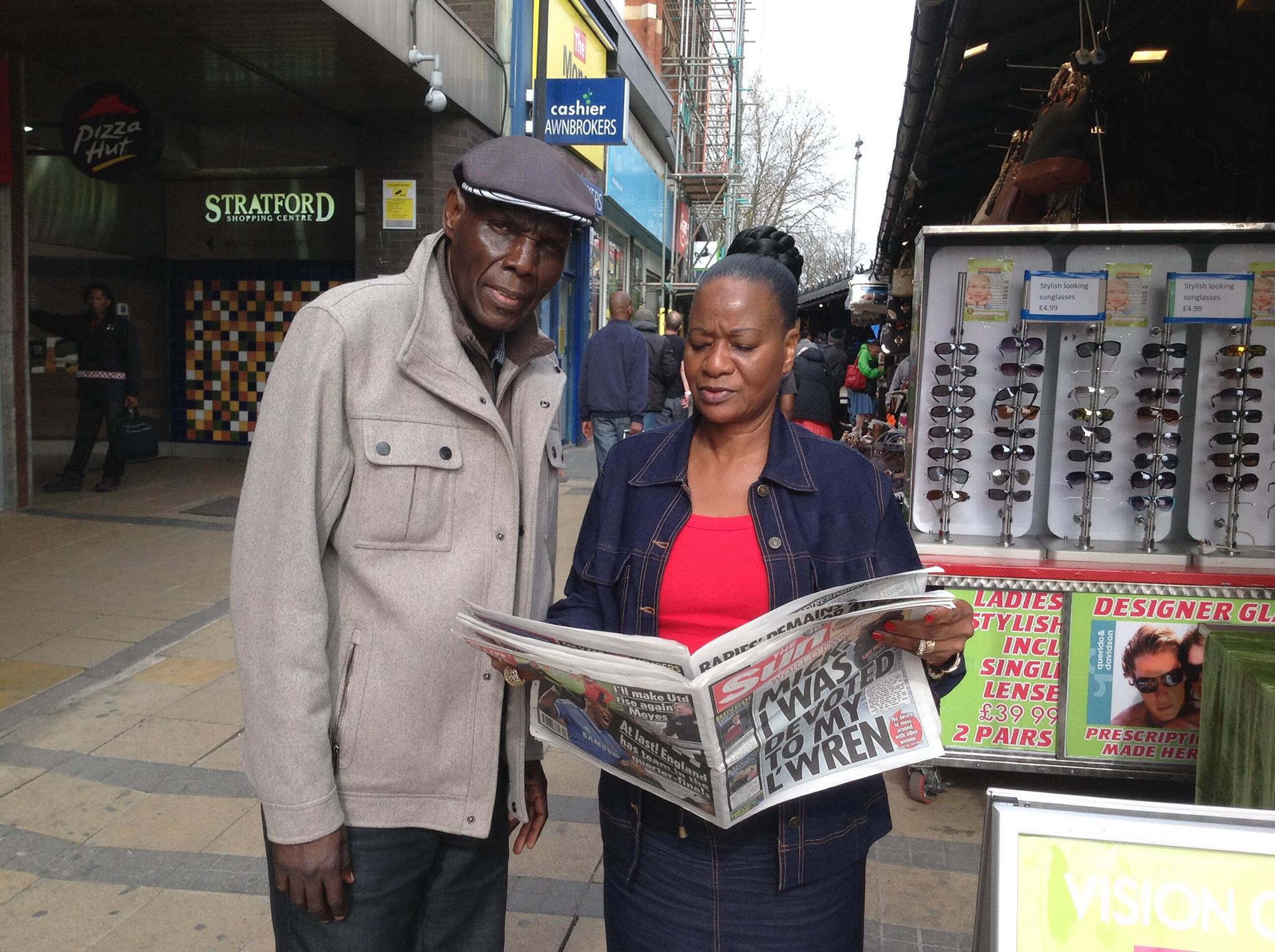 Oliver Mtukudzi and wife Daisy in the UK and reading British tabloid newspaper The Sun
