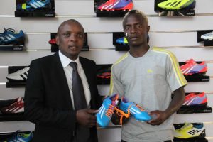 BRAND WITH THE THREE STRIPES . . . Zimbabwe international midfielder Kuda Mahachi (right) and the representative of Adidas in Zimbabwe Edzai Kasinauyo hold a pair of Adidas boots at a function in the capital yesterday where the Highlanders star was unveiled as a brand ambassador of the German sportswear giant. — Picture by Ruvimbo Chakanyuka