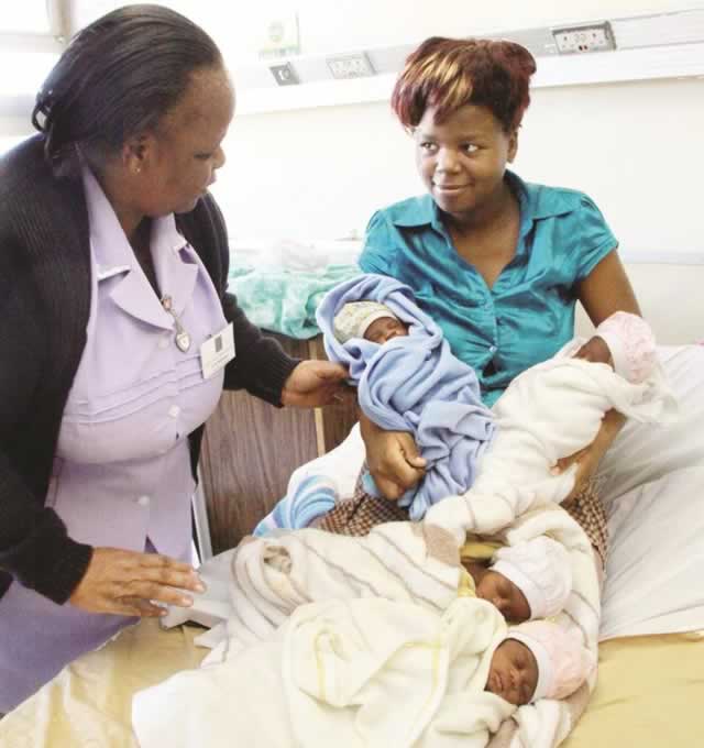 Mrs Alice Mutasa being assisted by Harare Central Hospital matron Mrs Dade Pedzisai after she gave birth to quadruplets — Sharline, Shanell, Shantel and Sharmaine — on May 19. — (Picture by Munyaradzi Chamalimba)