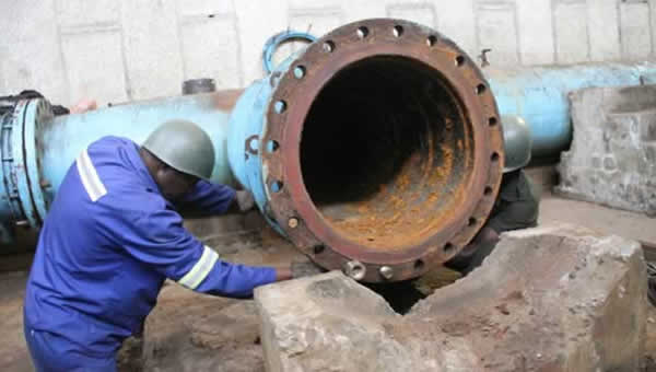 A Harare City worker examines one of the rusty pipes at Morton Jaffray Water Treatment Plant that will be replaced