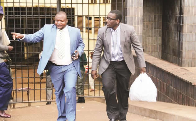 Sunday Mail editor Edmund Kudzayi (right) leaves the Harare Magistrates Courts in the company of his lawyer Mr Everson Chatambudza yesterday after being granted bail on Thursday. — (Picture by Ruvimbo Chakanyuka)