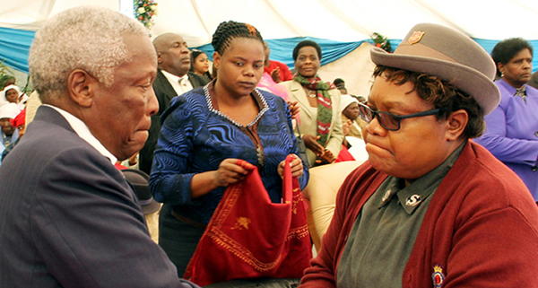 Vice-President Mujuru consoles Defence Minister Sydney Sekeramayi, who is fighting back tears during the memorial service of his late son Shungu in Harare yesterday. — Picture by Kudakwashe Hunda
