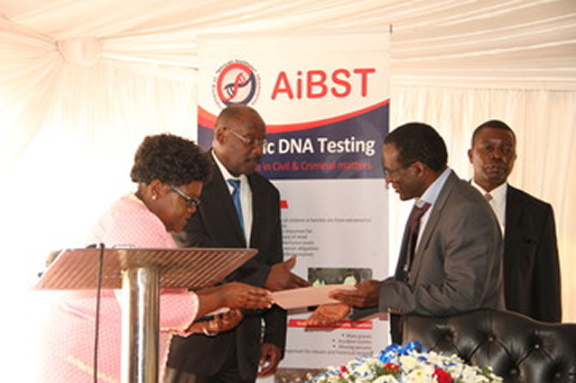 Acting President Joice Mujuru hands over a certificate of achievement to Professor Collins Masimirembwa during the official opening of AIBST DNA Laboratory at Wilkins Hospital in Harare yesterday, while Health and Child Care Minister David Parirenyatwa looks on. — (Picture by Tawanda Mudimu)