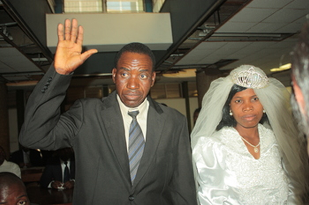 Mr Edson Murirana takes an oath during his wedding to his longtime sweetheart, Sheilla Nyamasoka, at the Harare Magistrates’ Courts yesterday before his day was ruined when both his legs were crashed by two vehicles while attempting to cross Rotten Row soon after the ceremony