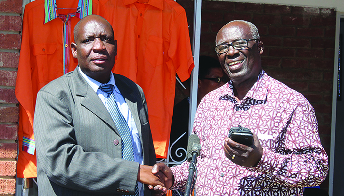 The Renewal Team national chairperson Samuel Sipepa Nkomo (R) welcomes Albert Mhlanga to their party