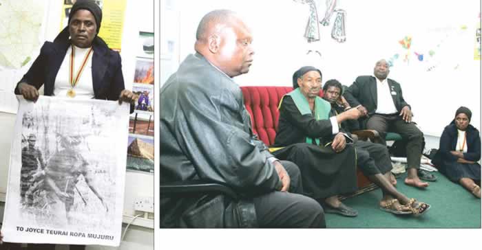 Linda Mangwende holds the poster with her portrait bearing Vice President Joice Mujuru`s name in Harare yesterday; Above: From left, Cde Rynos Mutodi, Tateguru Basvi Kuda Chikosha, Cde Joshua Kativhu and Cde Linda Mangwende, known as Cde Sarudzai Nehanda, listen to Tenzi Nehoreka (in gown) speaking in Harare