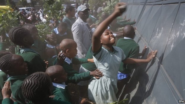 The children banged on the barrier to try to knock it down