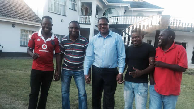Energy Mutodi (centre) shows off his mansion