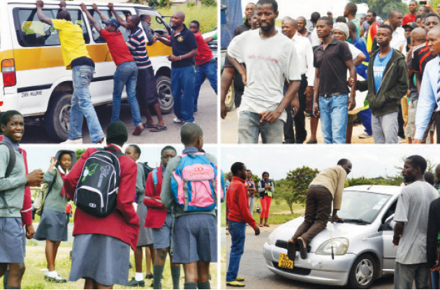 Stranded commuters try to find alternative transport as strike enforcers block transporters from ferrying passengers during a protest by kombi crews in Nketa, Bulawayo