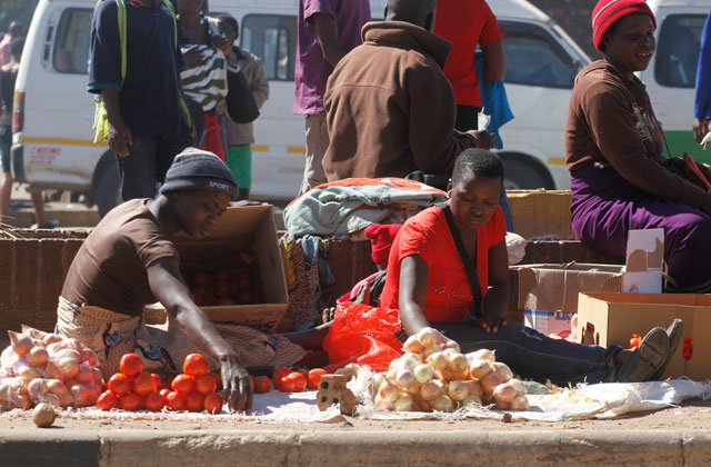 Vegetable vendors sell their wares along 4th street in Harare