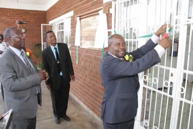 File Picture: Permanent Secretary in the Ministry of Higher and Tertiary Education, Science and Techology Development Dr Washington Mbizvo cuts the ribbon to officially open Padandaro Lodge in Mutare, while Mutare Poly principal Mr Tobias Kuwengwa (left) and a college staffer look on