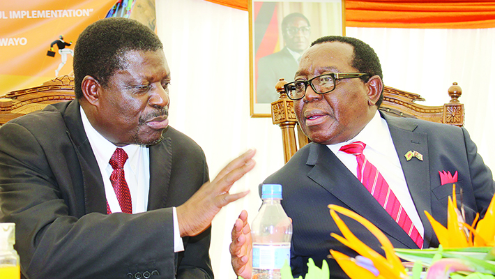 Zanu PF spokesman Simon Khaya Moyo (right)
