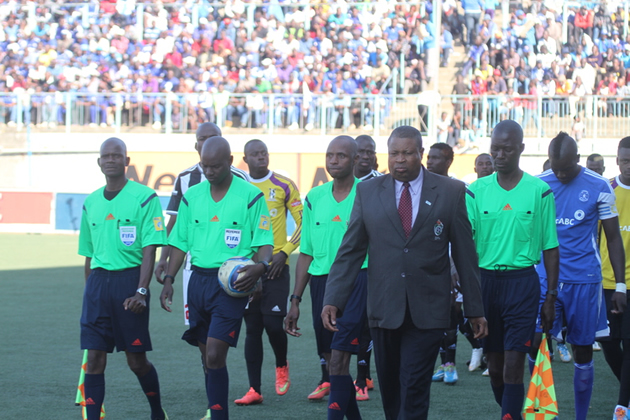 IN THE EYE OF THE STORM . . . Assistant referee Bongani Gadzikwa (left) and fellow match officials follow match commissioner Lovemore Marange as he leads the referees and teams onto the pitch just before Sunday’s epic clash between Dynamos and Highlanders