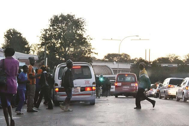 A commuter omnibus picks passengers at an undesignated pick up area along 6th Avenue in Bulawayo yesterday