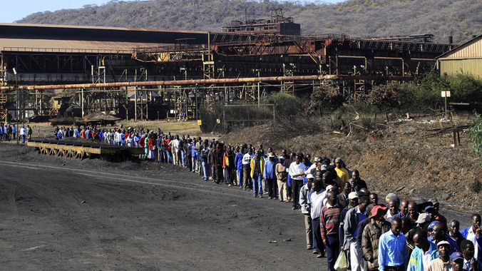 Zimbabwe Iron and Steel Company workers walk to its plant in Redcliff, Kwekwe