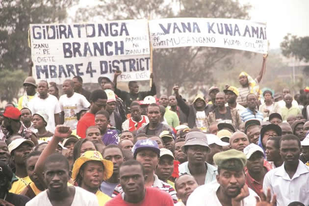 Youths displaying placards in Mbare yesterday. — Pictures by Munyaradzi Chamalimba