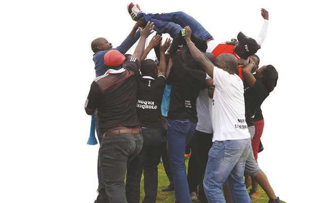 Tsholotsho FC coach Lizwe Sweswe is lifted by the team’s joyful fans after they drew 1-1 with Harare City at White City Stadium yesterday, a result which made sure that Iziqholo ZeZhwane extended their stay in the Castle Lager Premier Soccer League beyond this season