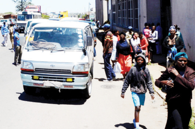 Commuters foot their way into town after being dropped off along Khami Road by kombi crews fearful of the heavy police presence in the Bulawayo CBD