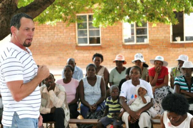 A group of Zimbabweans gives Gary Blick full attention as he explains the B.E.A.T. AIDS initiative